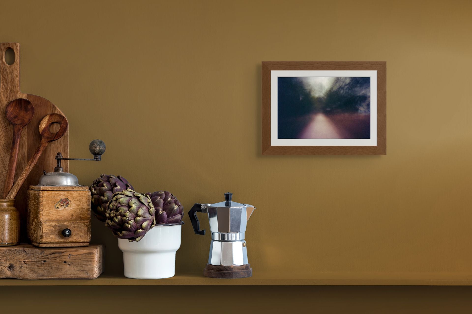 An abstract fine art photo of a blurry path in Athens, Greece, framed and hanging on the wall of a modern kitchen interior.