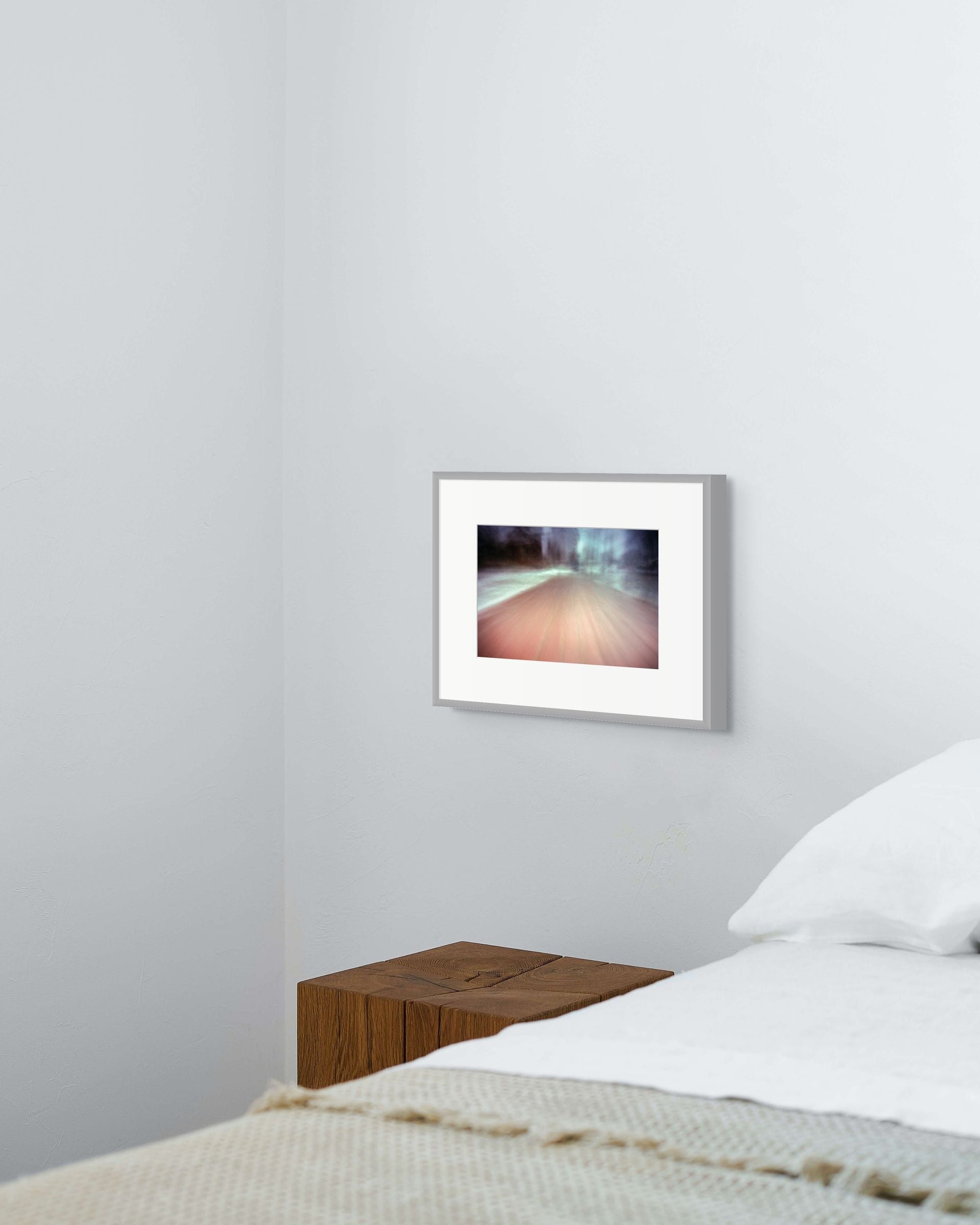 Fine art print on giclee paper of an abstract scene, hung on a wall of a bedroom interior.