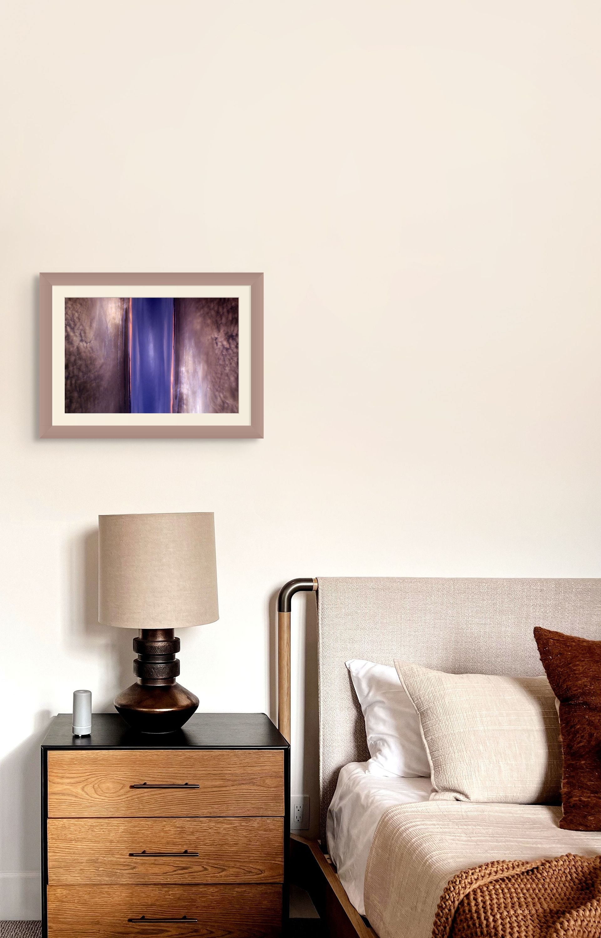 Abstract fine art photograph of a double exposure of a sky with clouds, framed and hung on the wall to complement the decor.