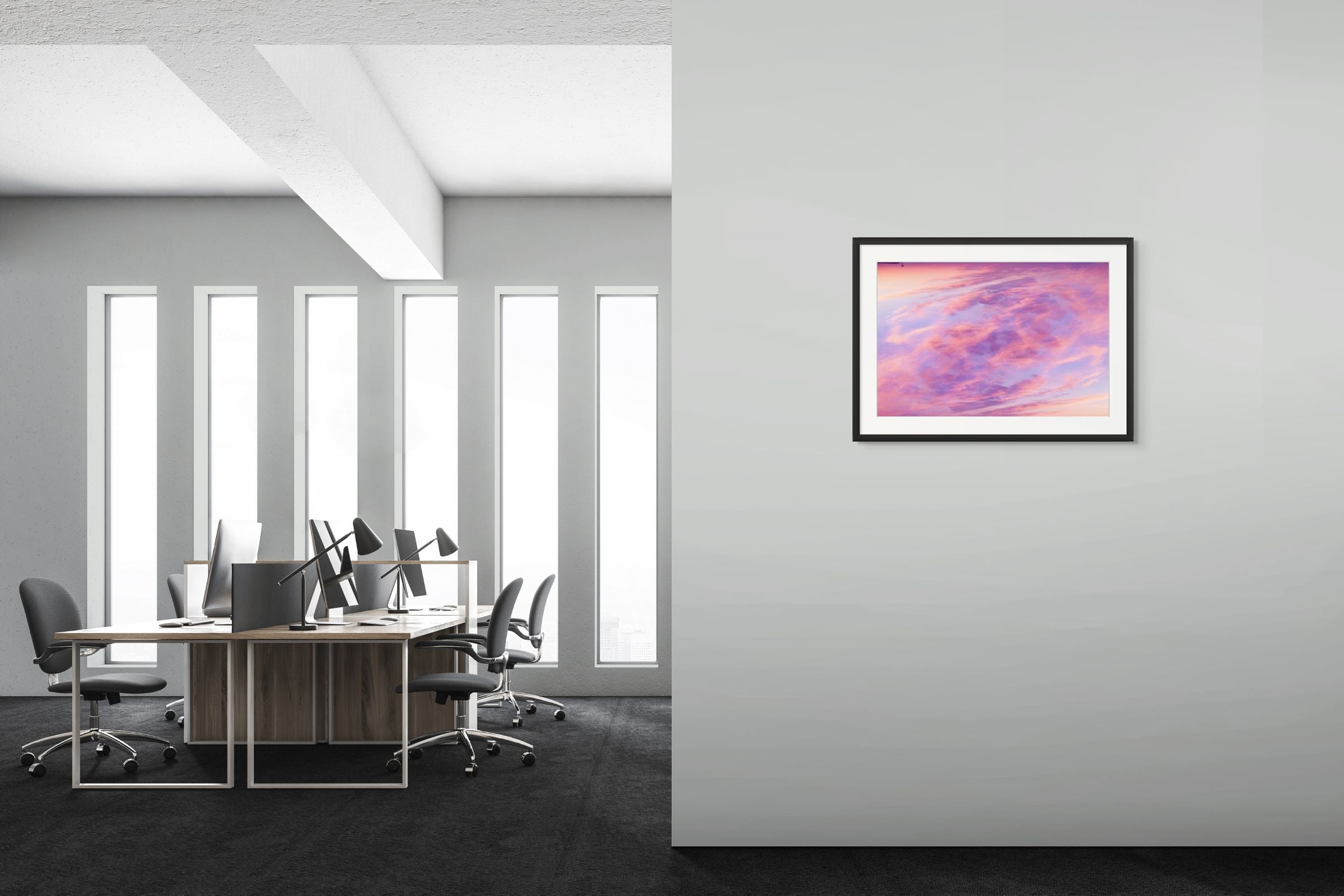A splash of color in the form of an abstract fine art photograph depicting a double exposure of a sunset sky over cape cod. It is framed and hung on the wall of a sleek interior.