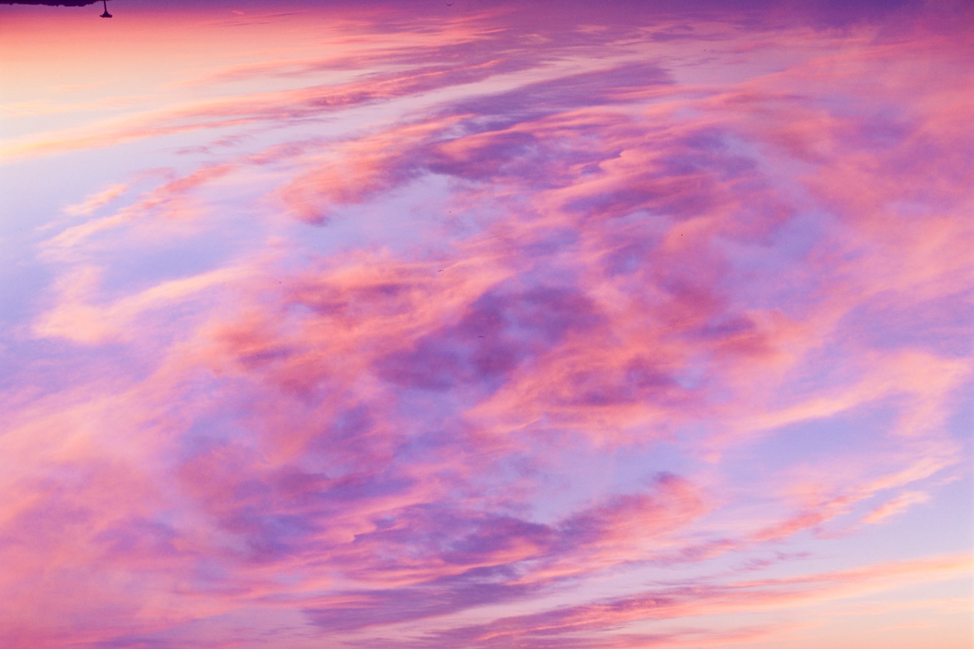 A splash of color in the form of an abstract fine art photograph depicting a double exposure of a sunset sky over cape cod. 