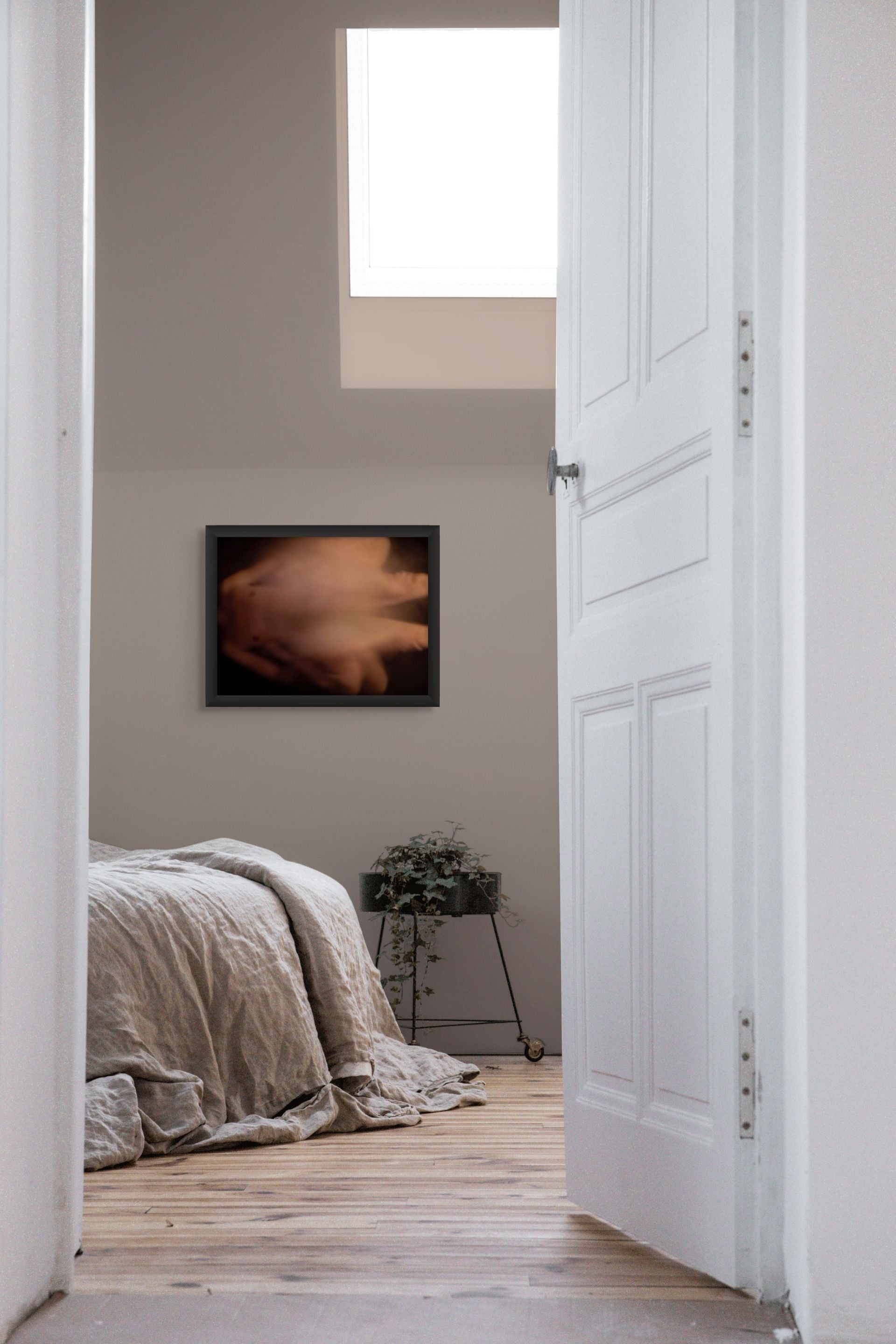 Impressionistic photo of sex in the abstract, printed on fine art giclee paper and hanging on a wall of a bedroom.