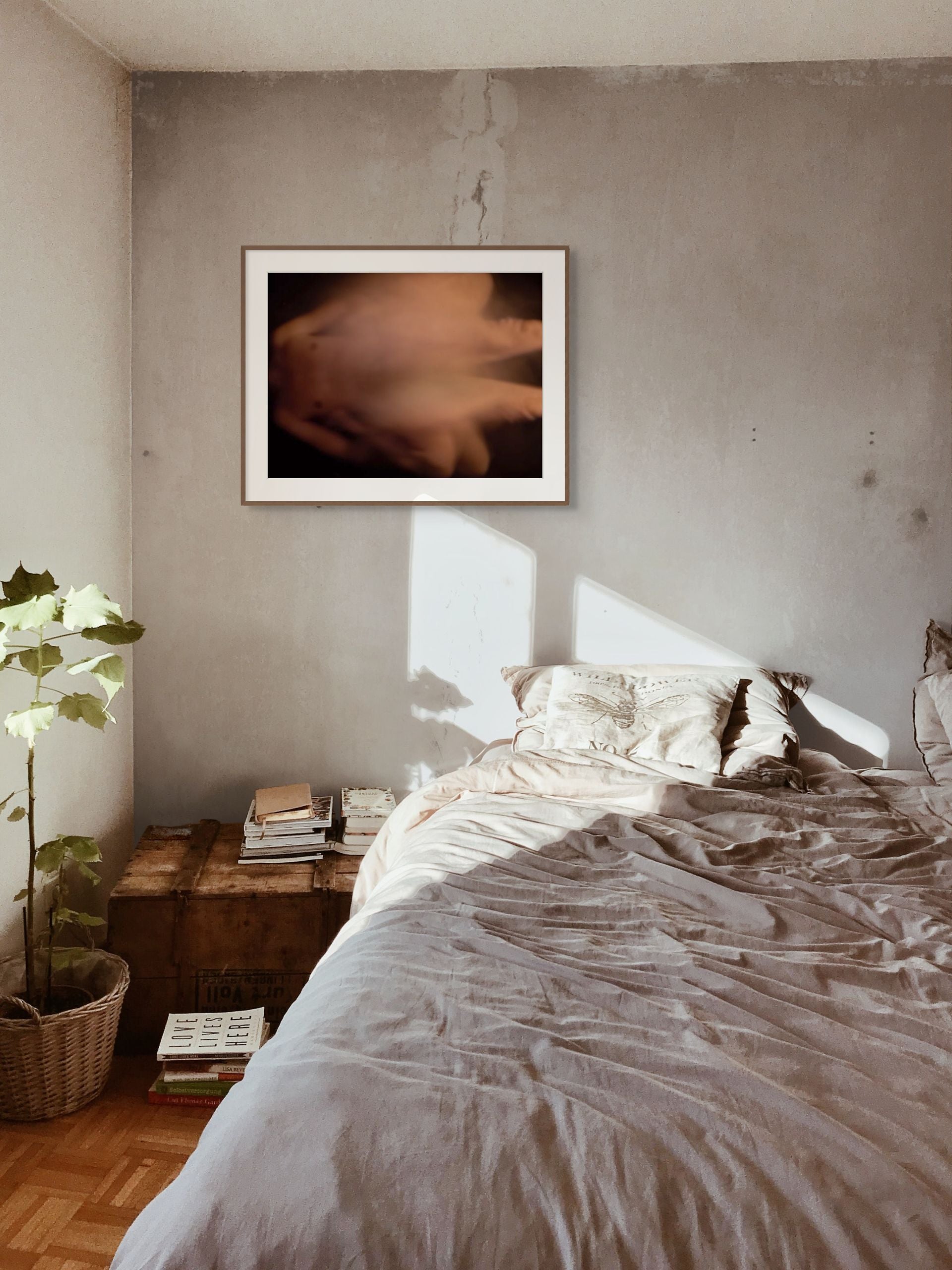 Impressionistic photo of sex in the abstract, printed on fine art giclee paper and hanging on a wall of a bedroom.
