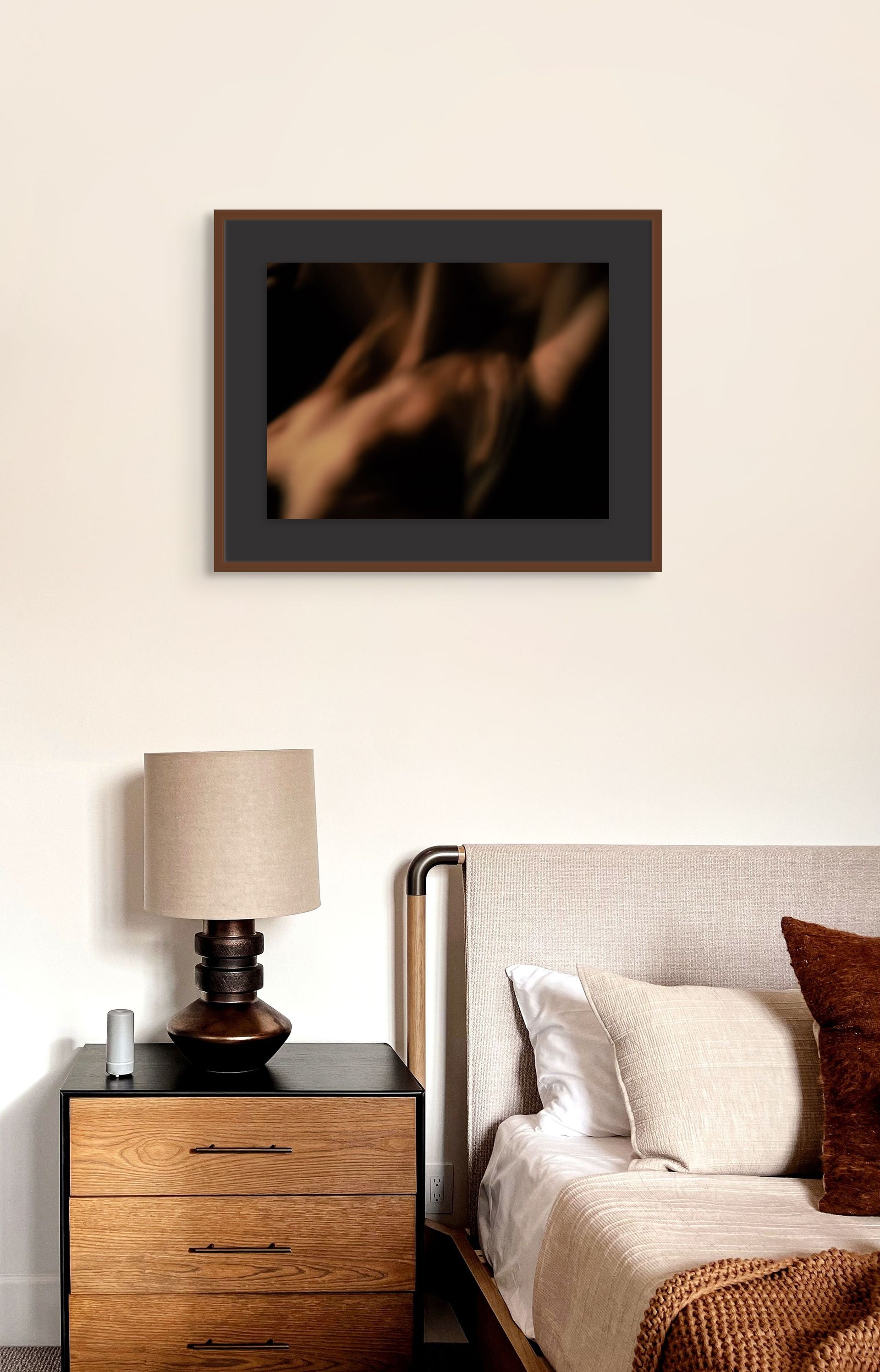 Abstract photo long exposure hanging on the wall of a bedroom.