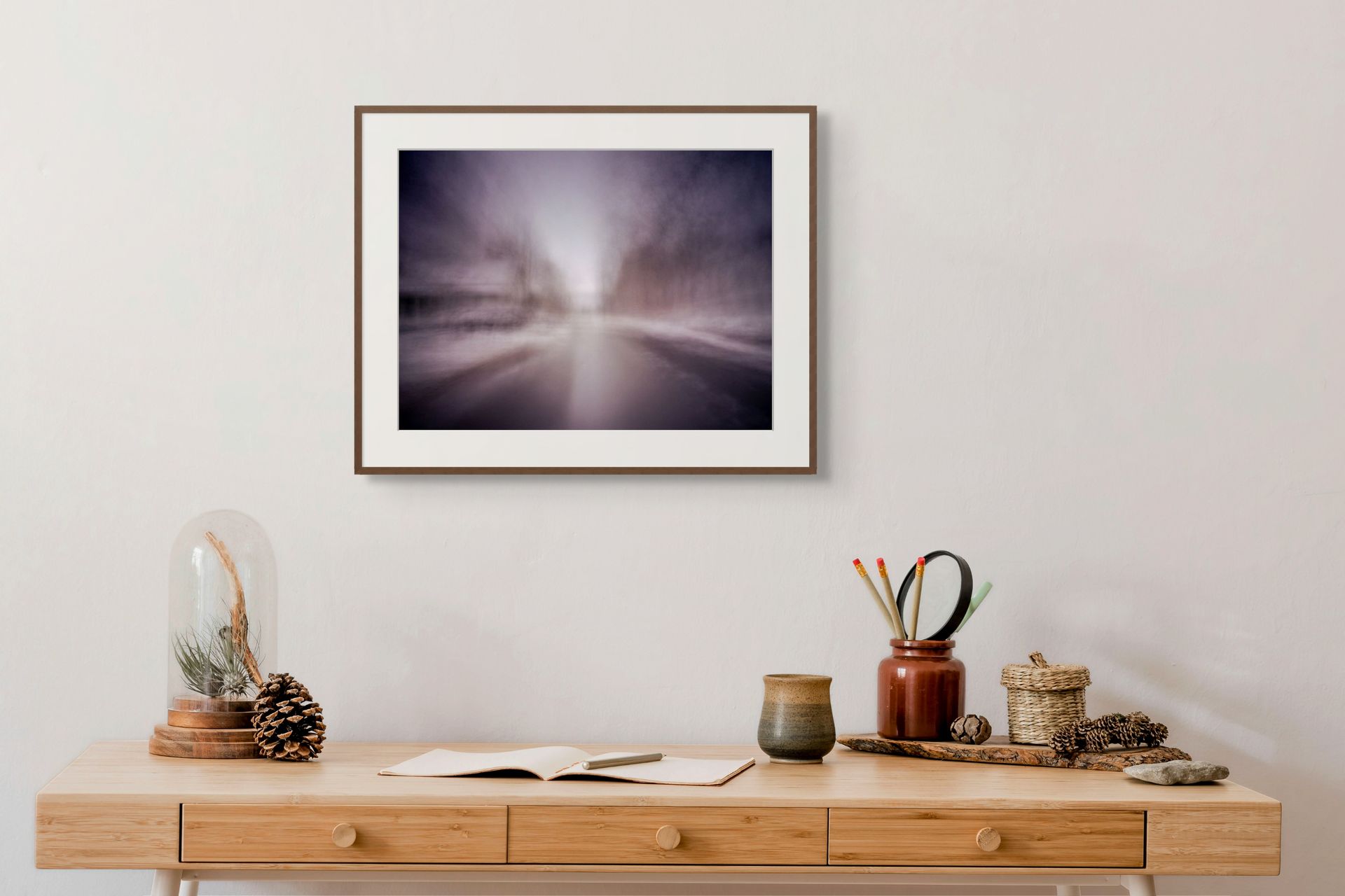 An abstract fine art print of a snowy landscape, framed and hung on the wall of a modern space.