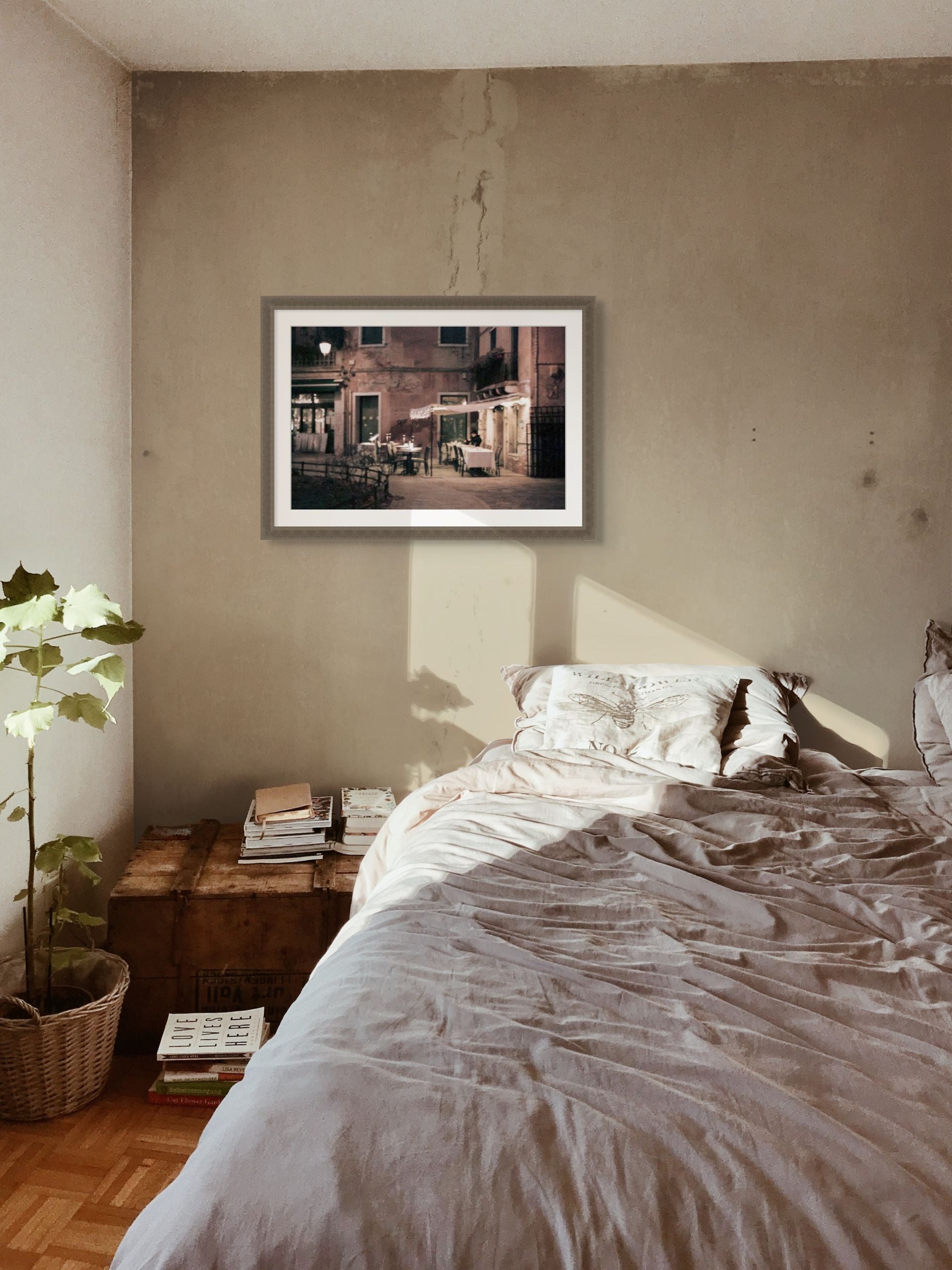 Old rustic interior with a framed fine art print of Venice at night. The picture is an abstract photo on giclee paper.