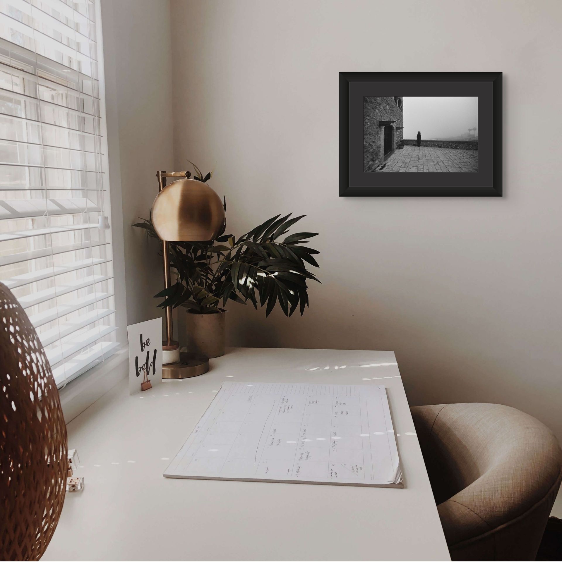 A misty fine art photo print on black and white ilford photo paper set in a modern home office scene.